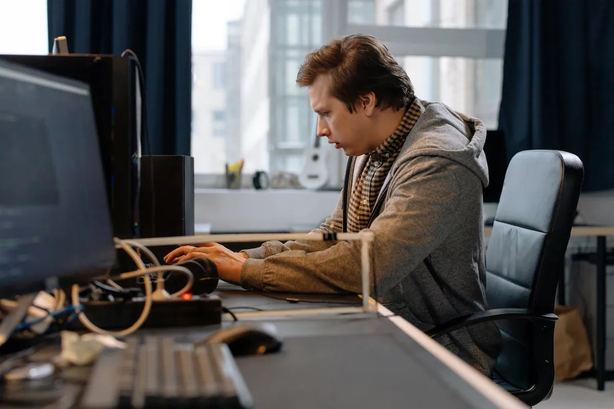 Photo of a man typing on a computer -- closing deals