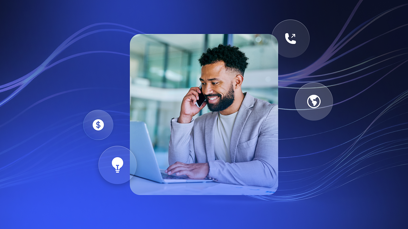 Man working on laptop while talking on smartphone, surrounded by icons including dollar sign, light bulb, and phone to indicate conversational AI.